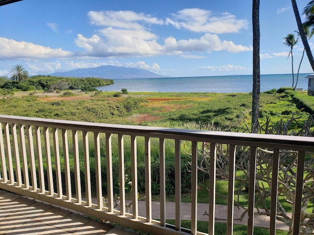 balcony featuring a water and mountain view