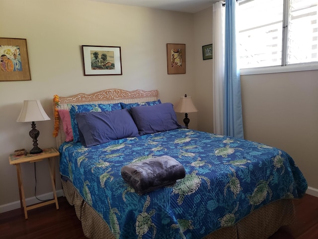 bedroom with dark hardwood / wood-style floors