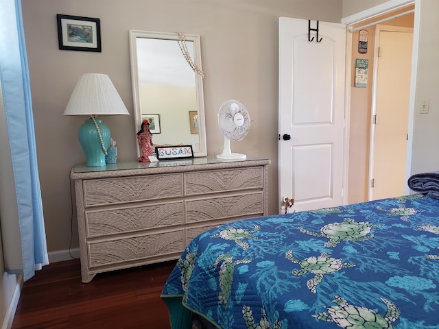 bedroom with dark hardwood / wood-style floors