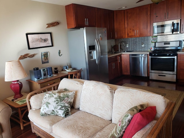 kitchen with decorative backsplash, dark hardwood / wood-style flooring, stainless steel appliances, and sink