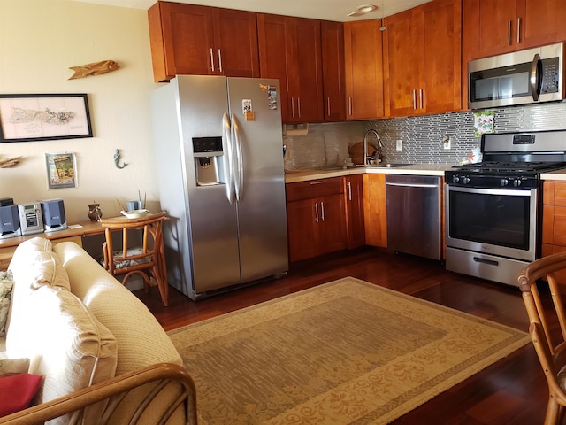 kitchen featuring dark hardwood / wood-style flooring, sink, stainless steel appliances, and tasteful backsplash