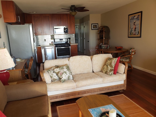 living room featuring wood-type flooring and ceiling fan