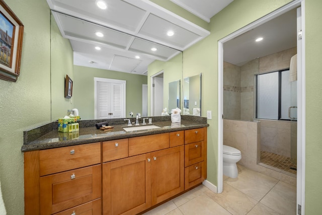 bathroom with tile patterned floors, vanity, an enclosed shower, and toilet