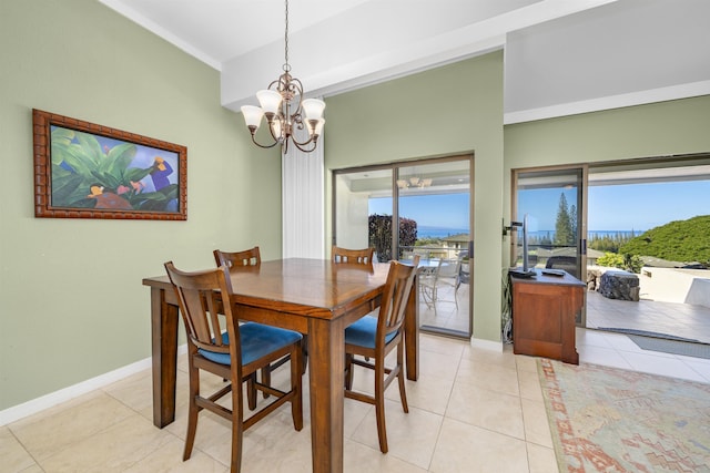 tiled dining space with a chandelier