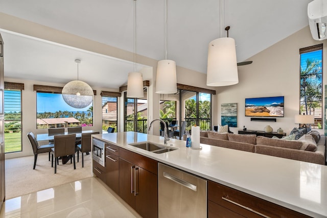 kitchen with appliances with stainless steel finishes, vaulted ceiling, pendant lighting, and sink