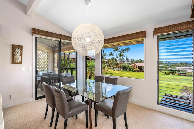 dining area featuring vaulted ceiling with beams and light colored carpet