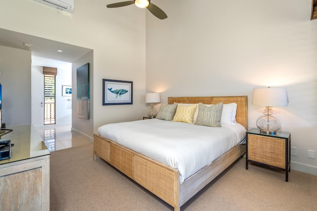 bedroom with ceiling fan, an AC wall unit, and light carpet