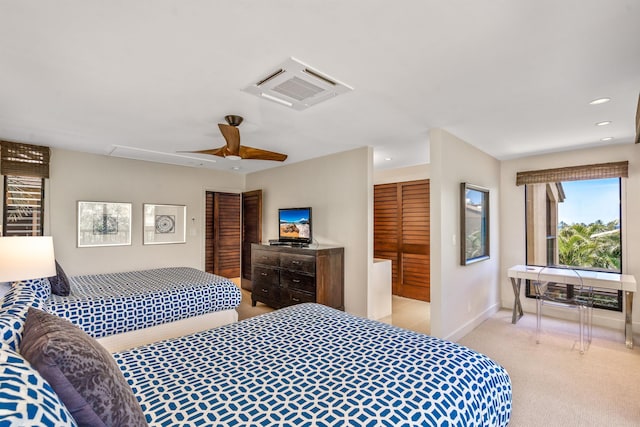 carpeted bedroom featuring a closet and ceiling fan