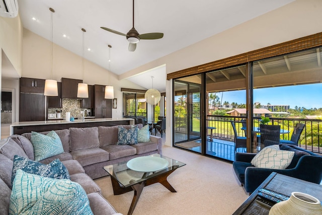 living room with a wall mounted AC, light colored carpet, high vaulted ceiling, and ceiling fan