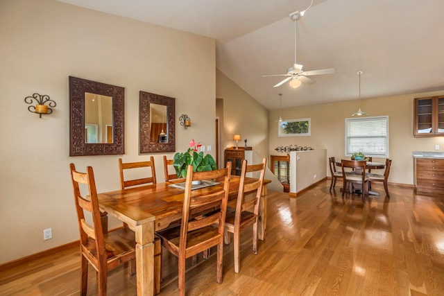 dining area featuring wood-type flooring, vaulted ceiling, and ceiling fan