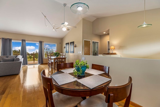 dining area with light hardwood / wood-style flooring, ceiling fan, and lofted ceiling