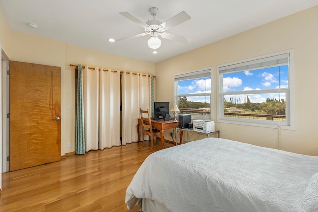 bedroom with ceiling fan and light hardwood / wood-style flooring