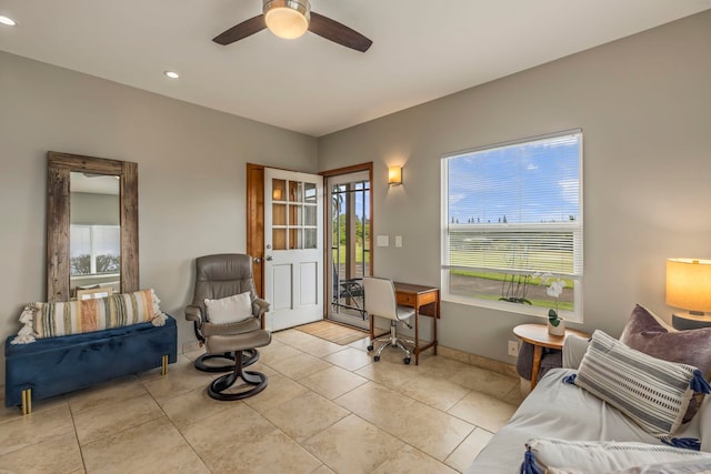 living area featuring ceiling fan and light tile patterned floors