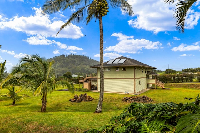 50 Uakoko Pl, Haiku, HI 96708 - view of property exterior with stairway, solar panels, a lawn, and a deck