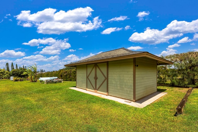 view of outdoor structure with a lawn