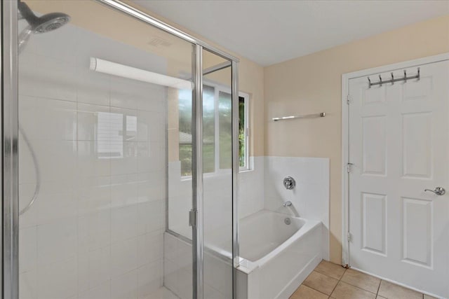 bathroom with tile patterned floors and independent shower and bath