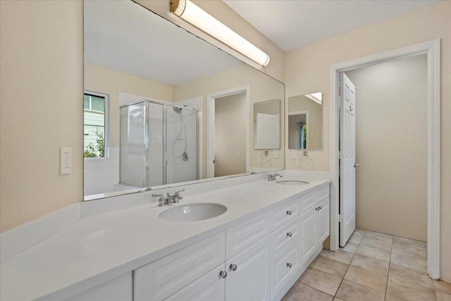 bathroom featuring tile patterned flooring, vanity, and a shower with shower door