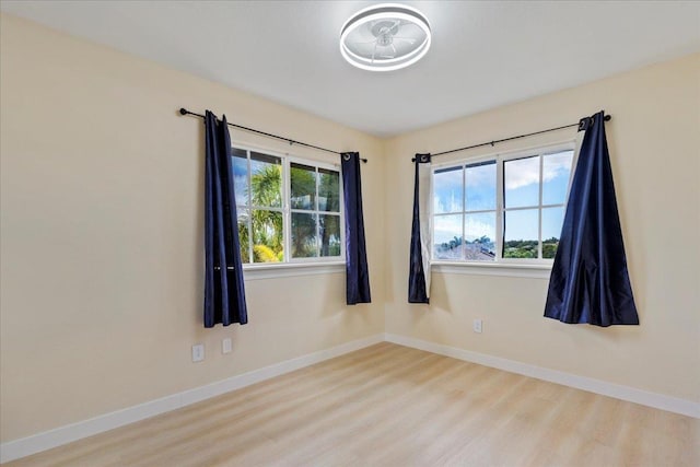 unfurnished room with light wood-type flooring