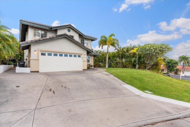 view of front of property featuring a front lawn and a garage