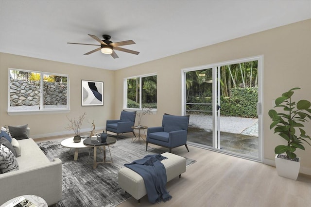 living room with ceiling fan and light hardwood / wood-style floors