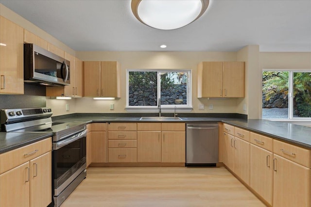 kitchen with sink, stainless steel appliances, and light brown cabinetry