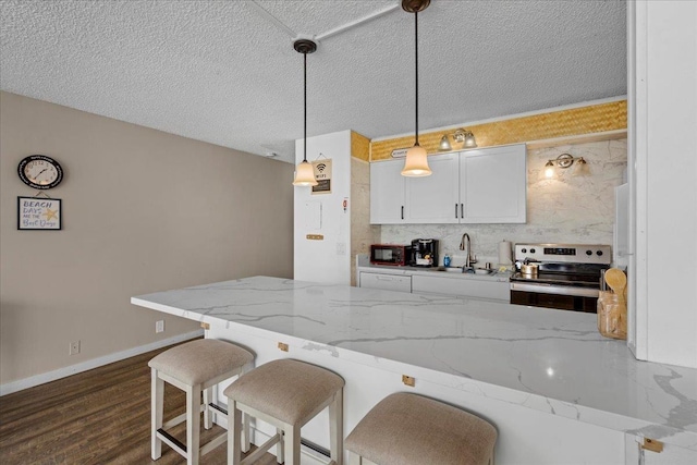 1993 S Kihei Rd Unit 308, Kihei, HI 96753 - kitchen with stainless steel range with electric cooktop, a sink, black microwave, a breakfast bar, and light stone countertops