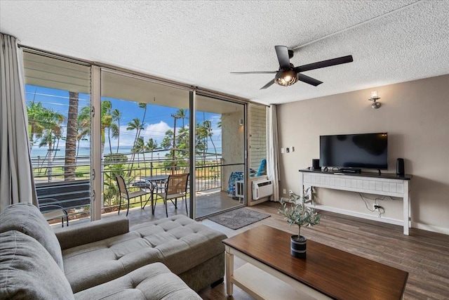 1993 S Kihei Rd Unit 308, Kihei, HI 96753 - living room with floor to ceiling windows, a ceiling fan, plenty of natural light, wood finished floors, and a textured ceiling