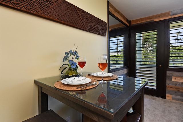 carpeted dining area featuring plenty of natural light