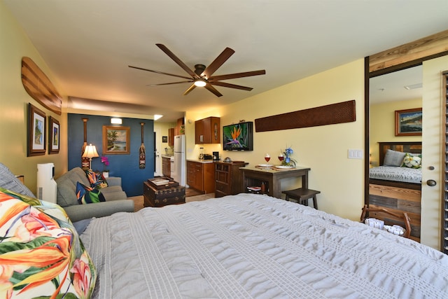 bedroom featuring ceiling fan and white refrigerator