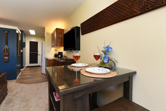 kitchen with hardwood / wood-style floors and white refrigerator