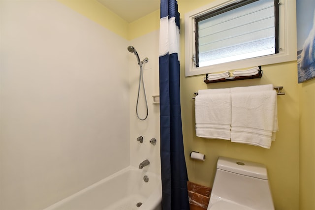 bathroom featuring toilet and shower / bath combo with shower curtain