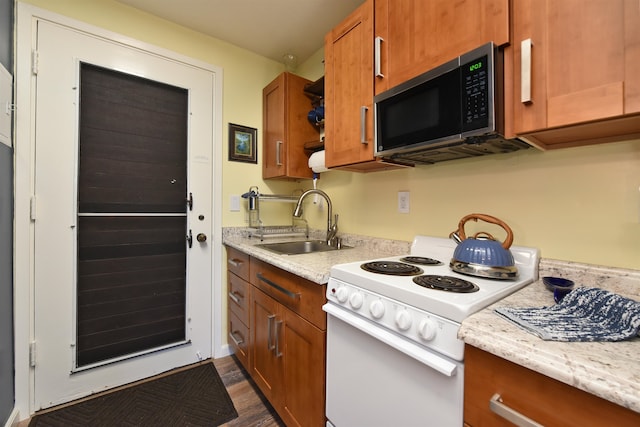 kitchen featuring dark hardwood / wood-style floors, light stone countertops, electric stove, and sink