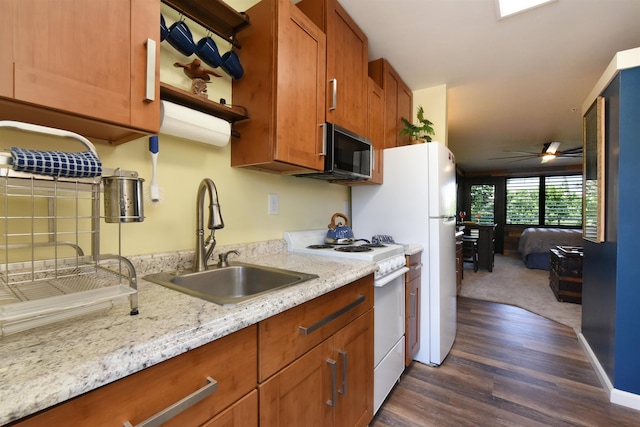 kitchen featuring light stone counters, ceiling fan, white range with gas cooktop, dark wood-type flooring, and sink