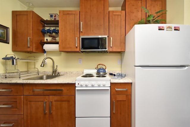 kitchen featuring white appliances and sink