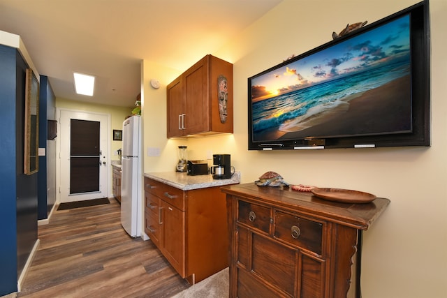 kitchen with dark hardwood / wood-style flooring and white refrigerator