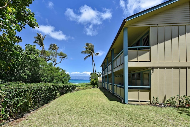 view of yard with a water view and a balcony