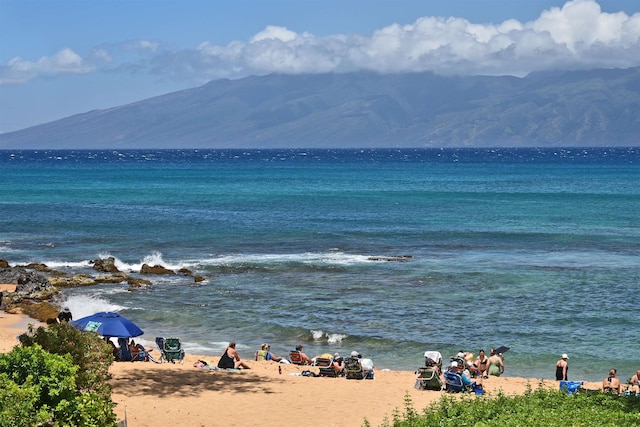 view of water feature featuring a mountain view and a beach view