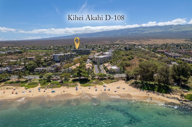 bird's eye view featuring a view of the beach and a water and mountain view