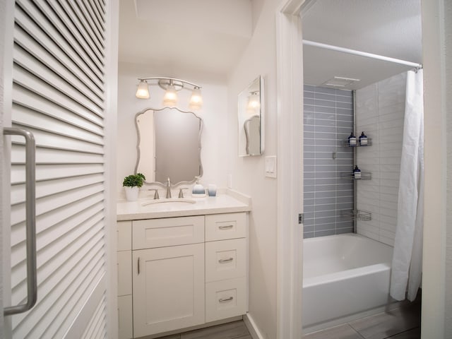 bathroom featuring wood-type flooring, vanity, and shower / bathtub combination with curtain