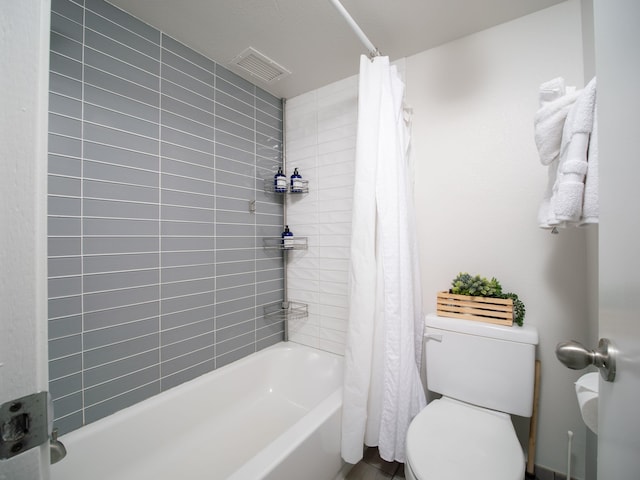 bathroom featuring toilet and shower / bath combo with shower curtain