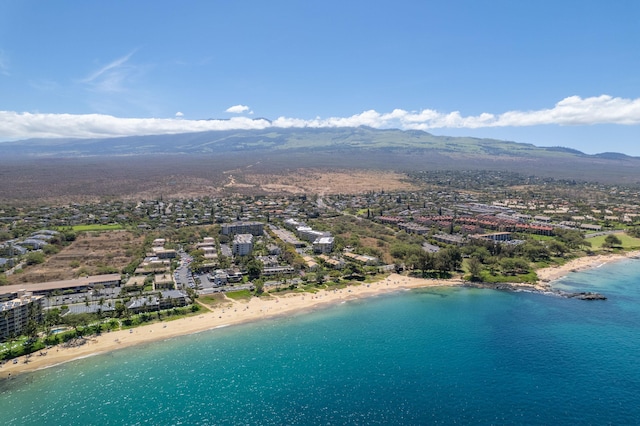 birds eye view of property featuring a water and mountain view and a view of the beach