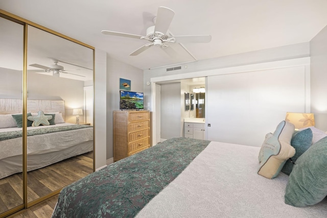 bedroom with wood-type flooring, a closet, and ceiling fan