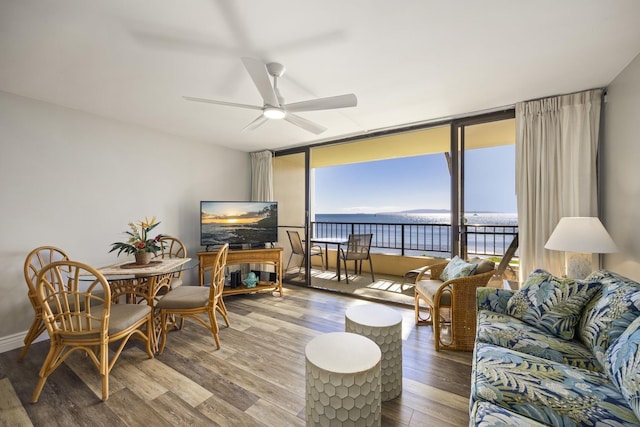 living room with hardwood / wood-style flooring, expansive windows, and ceiling fan