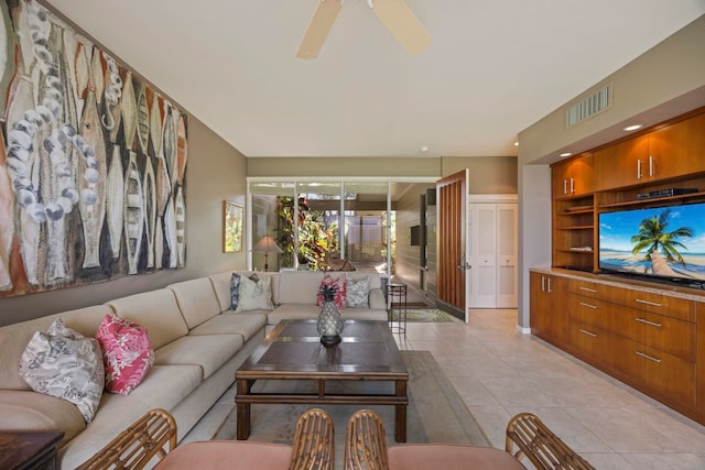 living room with ceiling fan and light tile patterned floors