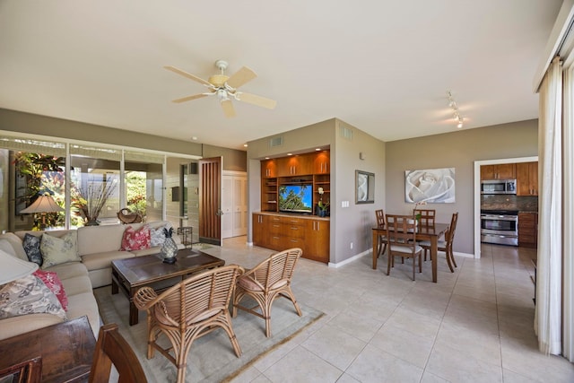 living room with ceiling fan and light tile patterned floors