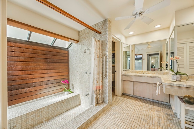 bathroom with a shower with curtain, vanity, tile patterned flooring, and ceiling fan