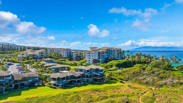 birds eye view of property with a water and mountain view