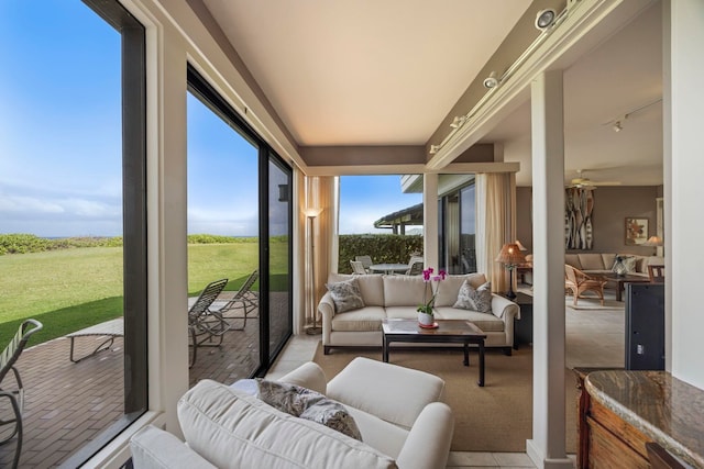 sunroom featuring plenty of natural light and ceiling fan