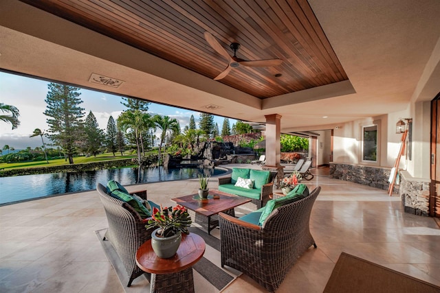 view of patio / terrace featuring an outdoor living space, a water view, and ceiling fan