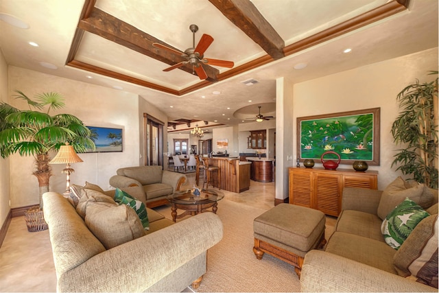 living room featuring a tray ceiling and ceiling fan